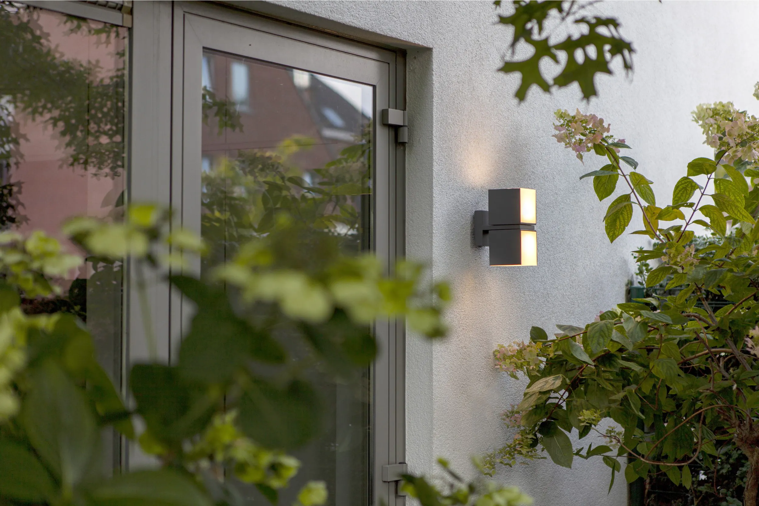 Moderne graue Wandleuchte neben einer Terrassentür