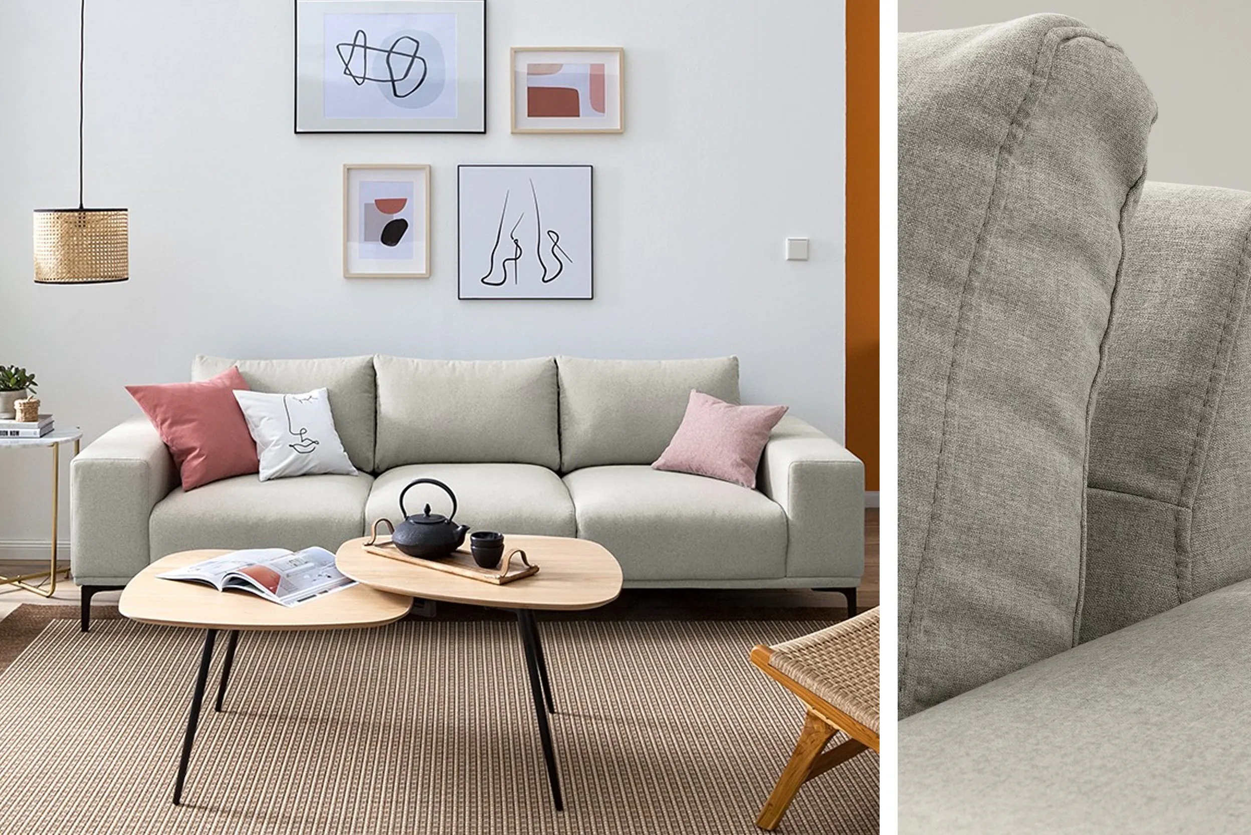 Graues Sofa mit Couchtisch und bunten Kissen sowie Bilder an der Wand