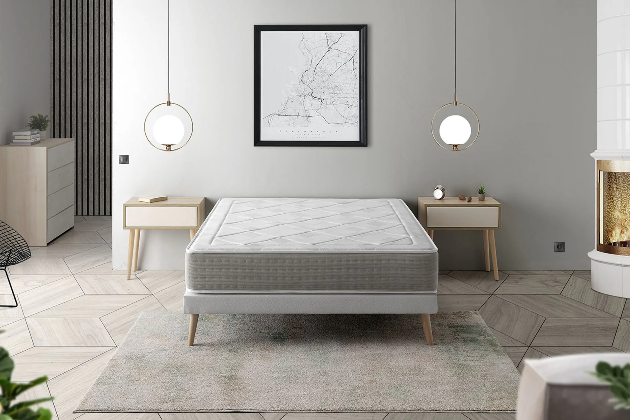 Schlafzimmer mit Kamin, Nachttischen, Pendelleuchten und Bett mit Boxspringmatratze