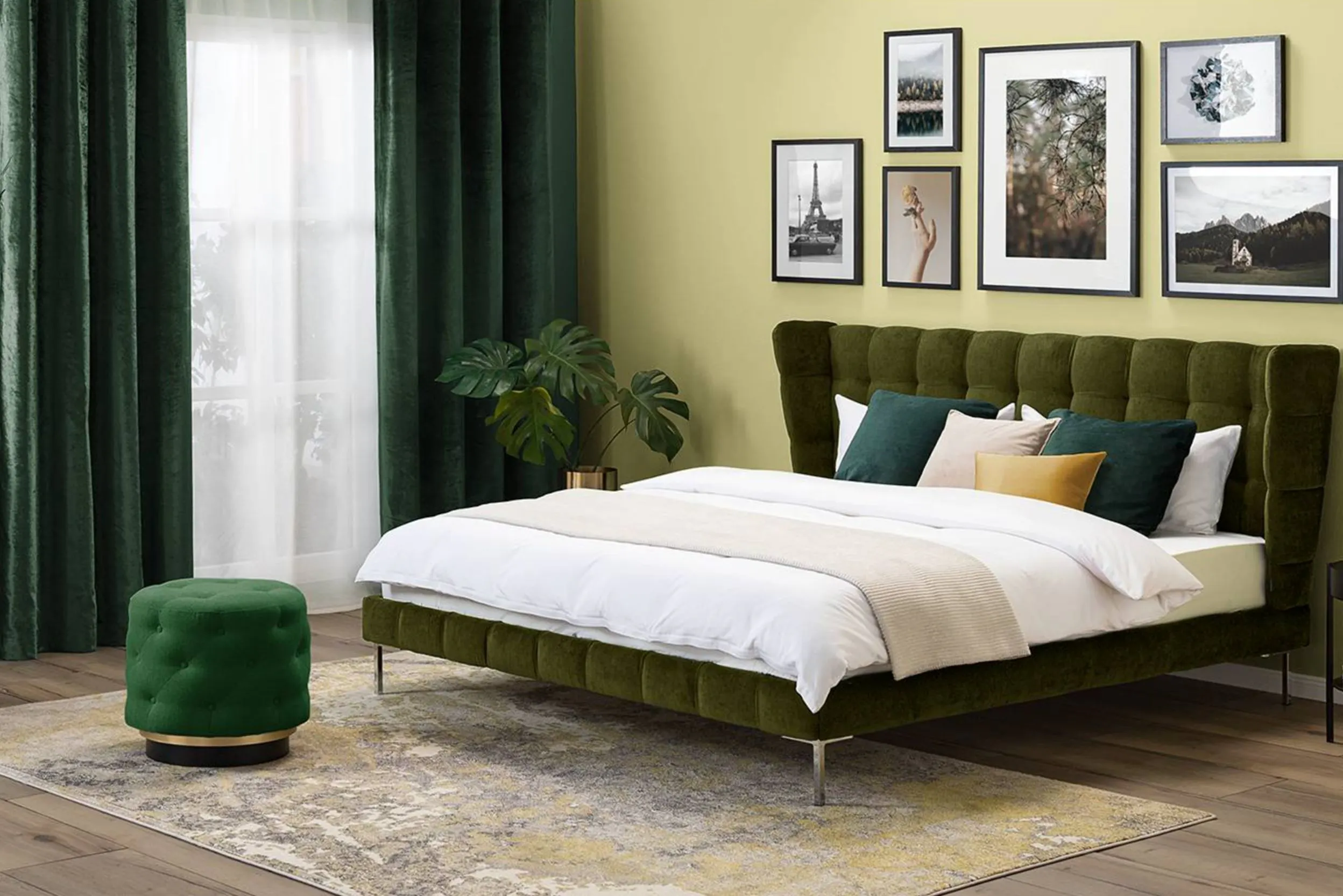 Elegantes Zimmer mit einem grünen Samtbett, tiefgrünen Vorhängen und einer schwarz-weißen Fotogalerie