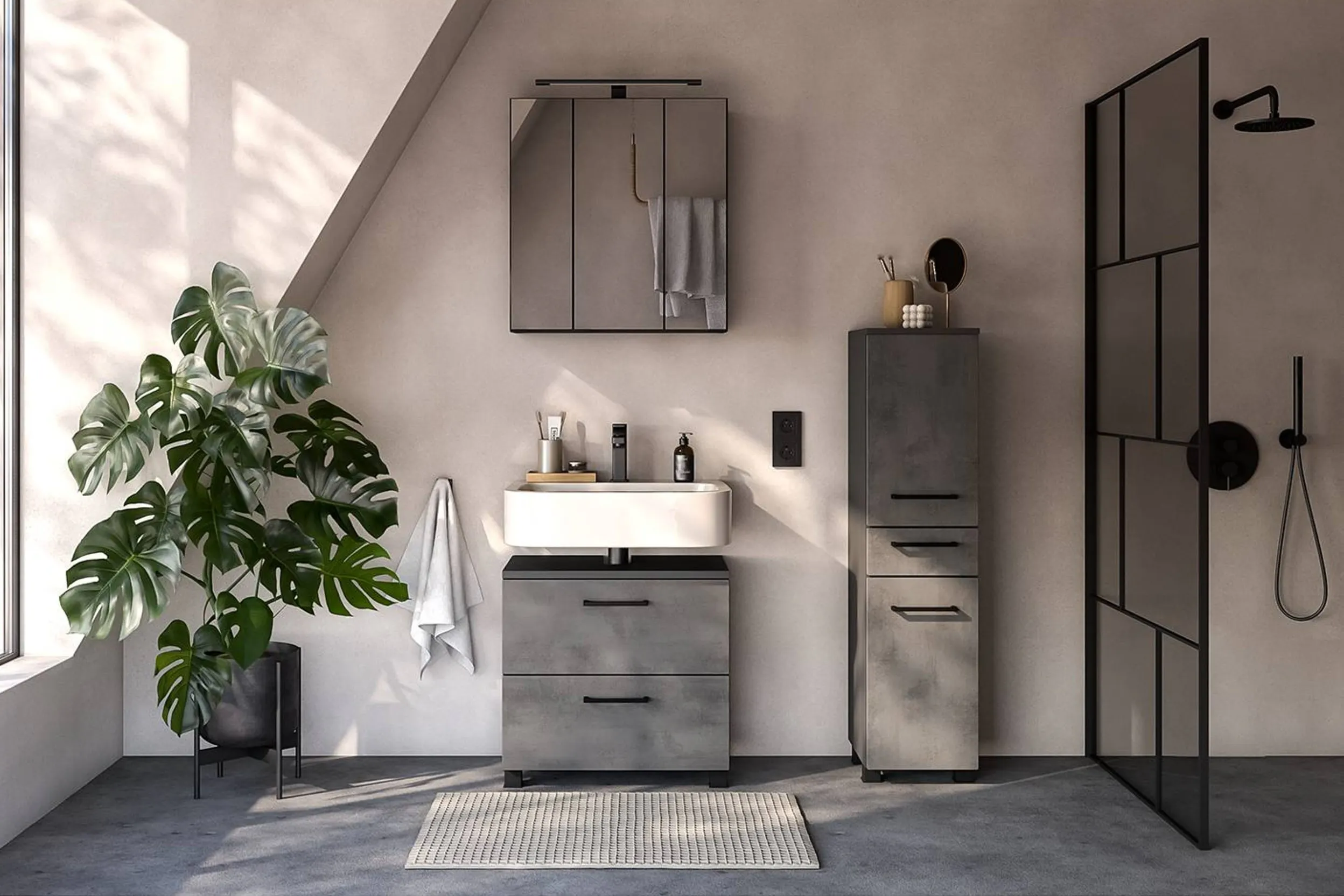 Bad mit Möbeln in Betonoptik, großer Pflanze und schwarzer Duschtrennwand
