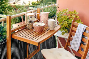 Einrichtungsideen für einen kleinen Balkon mit Klapptisch und Klappstuhl.